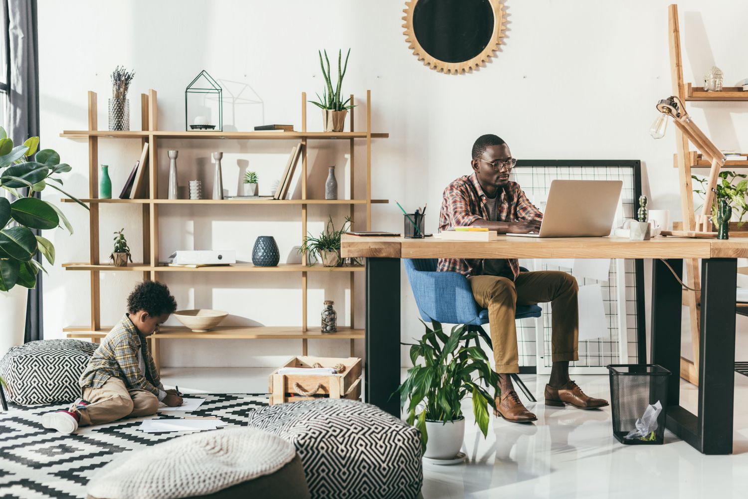 man working home office with child playing